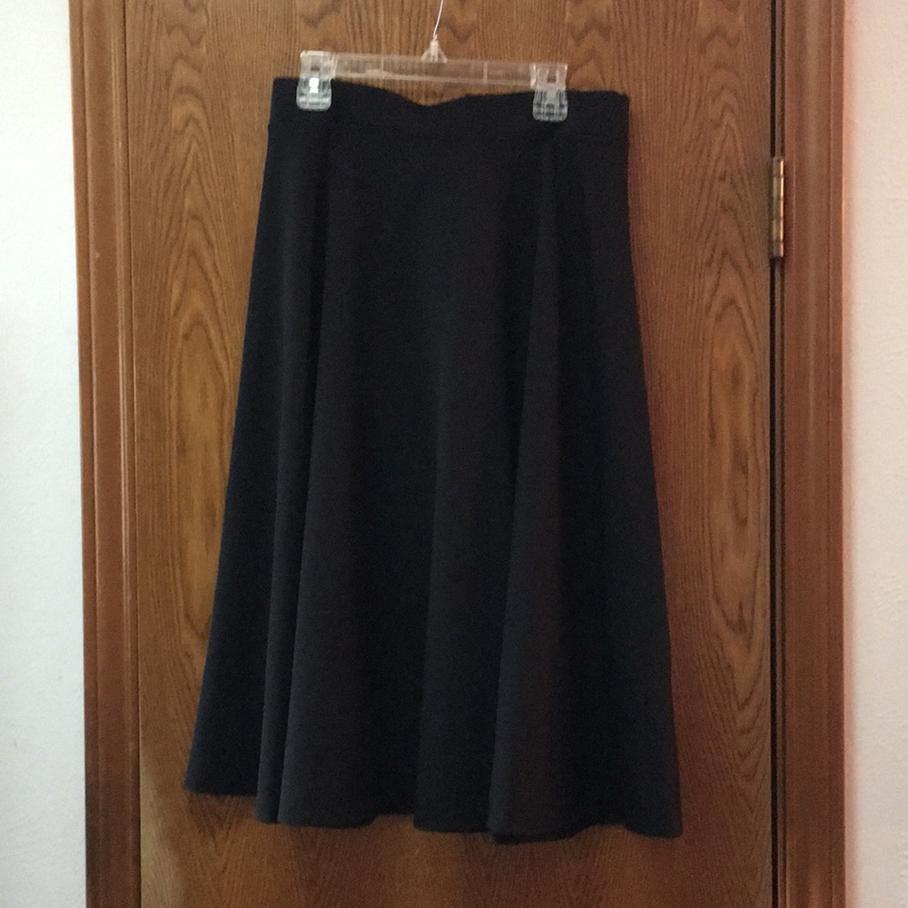 Polyester, elastic waist skirt with a beautiful flow and drape; knee length